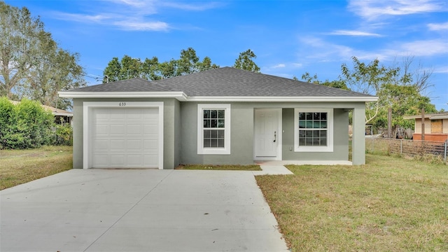 ranch-style home featuring a garage and a front lawn