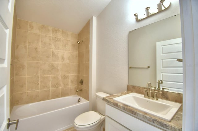 full bathroom featuring tiled shower / bath combo, toilet, and vanity