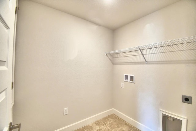 laundry room with electric dryer hookup, light tile patterned flooring, and hookup for a washing machine