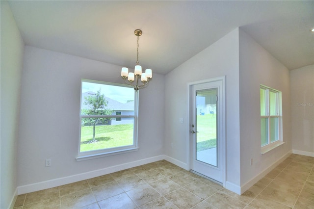 unfurnished dining area with vaulted ceiling, an inviting chandelier, a healthy amount of sunlight, and light tile patterned flooring