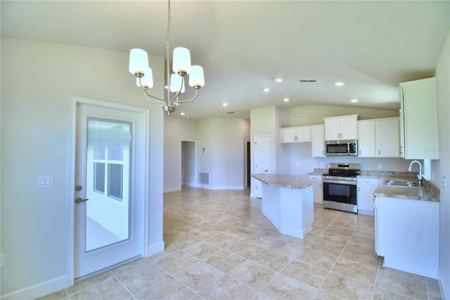 kitchen with stainless steel appliances, pendant lighting, a notable chandelier, white cabinets, and a center island