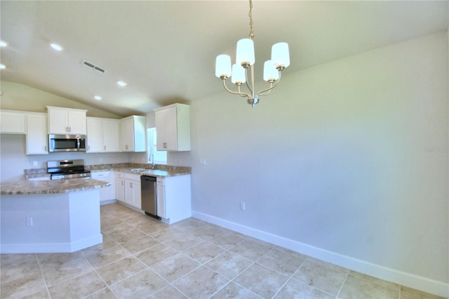 kitchen with sink, a notable chandelier, vaulted ceiling, white cabinets, and appliances with stainless steel finishes