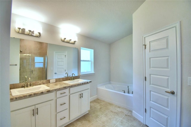 bathroom featuring tile patterned flooring, shower with separate bathtub, a textured ceiling, and vanity