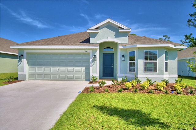 view of front facade featuring a front yard and a garage