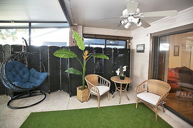 sunroom featuring ceiling fan