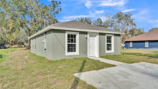 view of front of house featuring a front yard and a patio