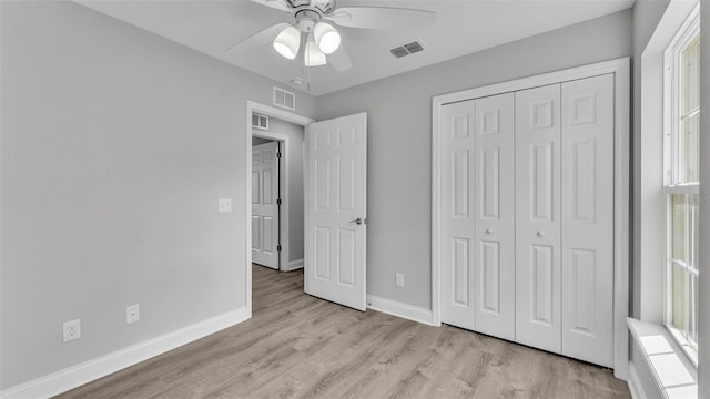 unfurnished bedroom featuring a closet, ceiling fan, and light wood-type flooring