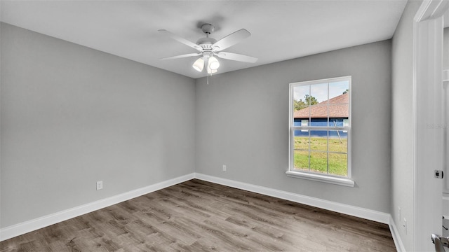 spare room featuring hardwood / wood-style floors and ceiling fan