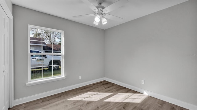 unfurnished room with ceiling fan, a healthy amount of sunlight, and light hardwood / wood-style floors