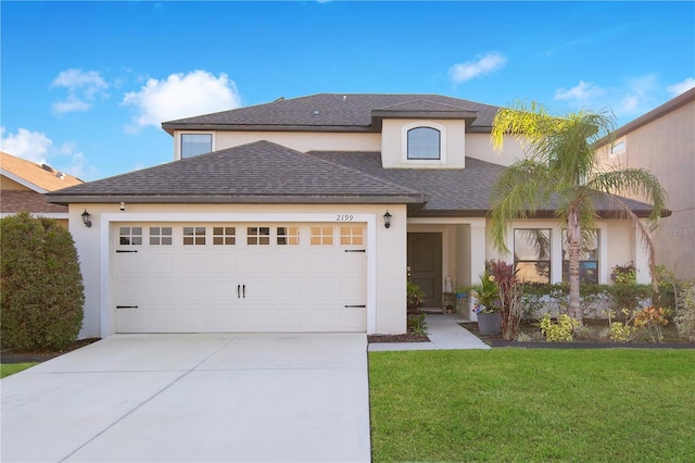 view of front of home with a front yard and a garage