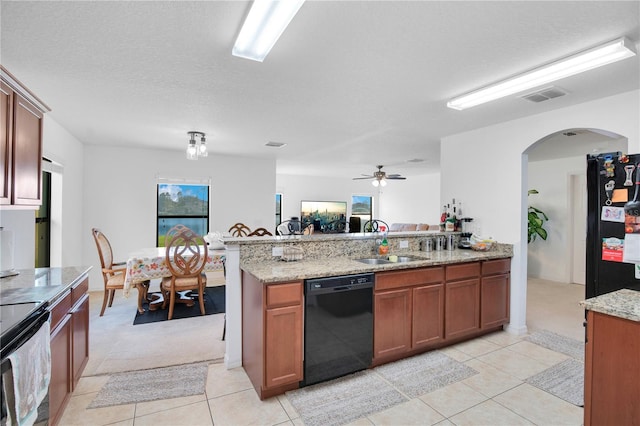 kitchen with light stone countertops, a textured ceiling, ceiling fan, sink, and black appliances