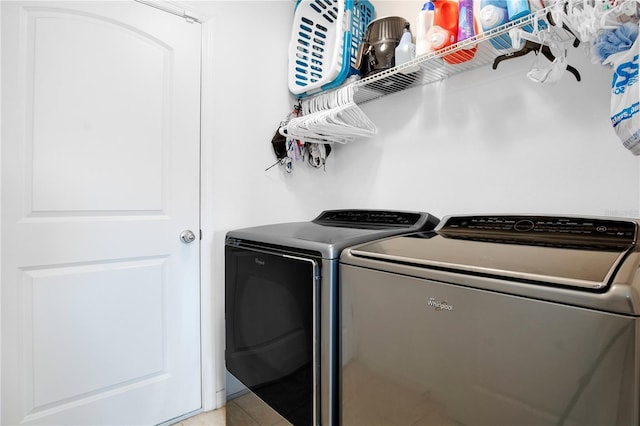 clothes washing area with tile patterned flooring and independent washer and dryer