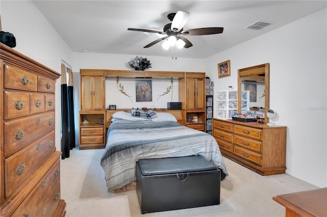 bedroom with ceiling fan and light colored carpet