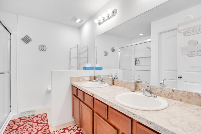 bathroom with tile patterned floors, vanity, and a shower with shower door