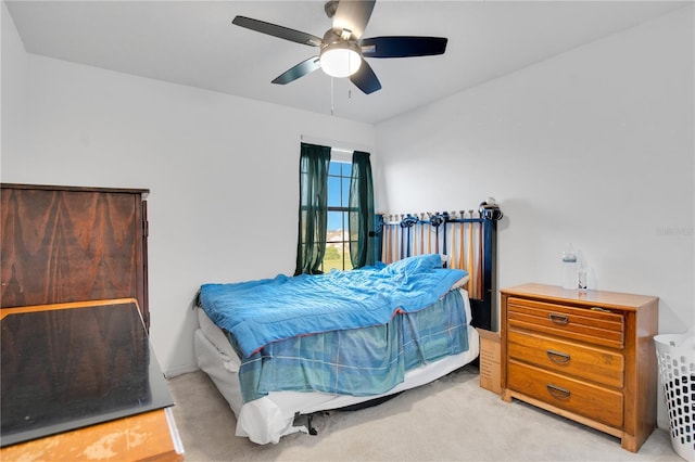 bedroom with ceiling fan and light carpet