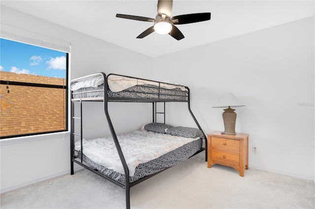 bedroom with ceiling fan and light carpet