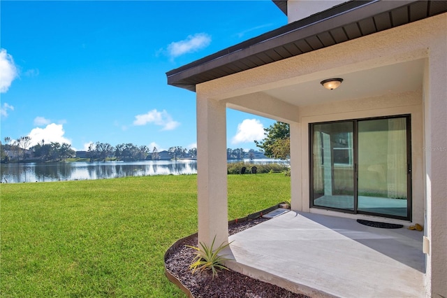 view of yard with a patio area and a water view