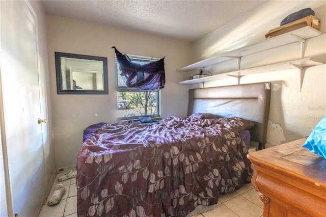 tiled bedroom featuring a textured ceiling