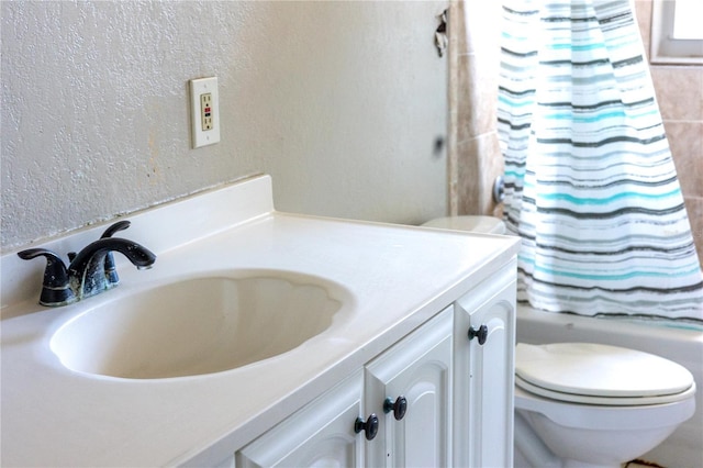 full bathroom with vanity, toilet, and shower / bath combo with shower curtain