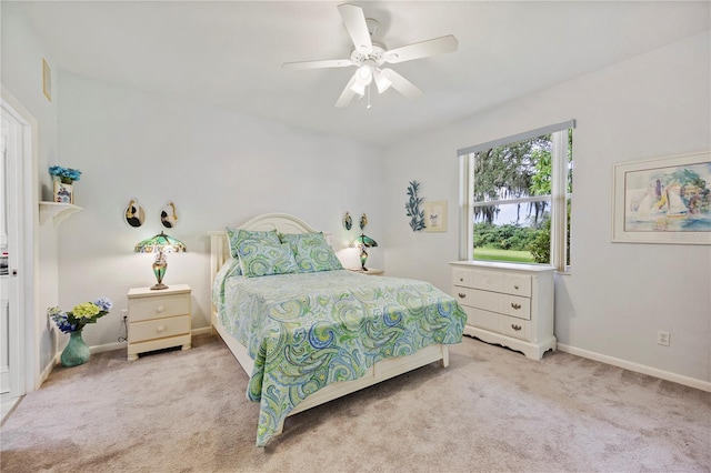 bedroom with light colored carpet and ceiling fan