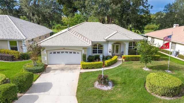 view of front of house with central AC unit, a garage, and a front lawn