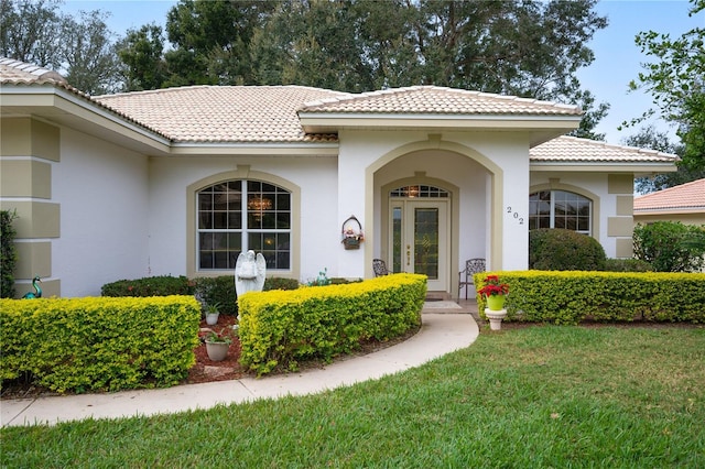 entrance to property with a lawn