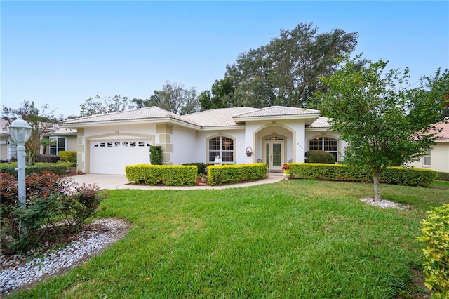 view of front of home featuring a garage and a front lawn