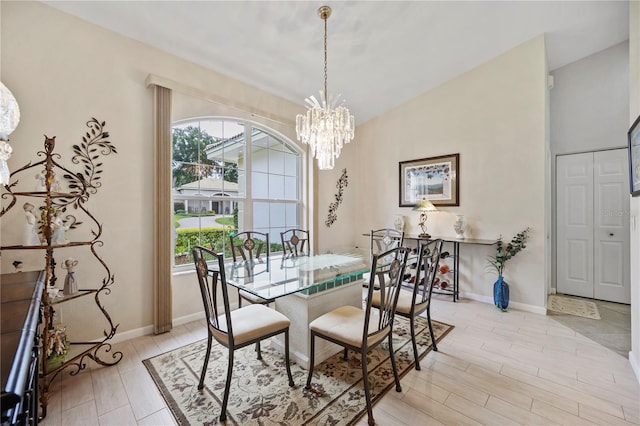 dining room with a chandelier, a wealth of natural light, and light hardwood / wood-style floors