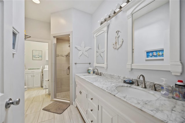 bathroom featuring a shower with shower door, tile patterned floors, and vanity