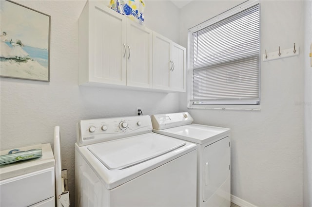 washroom with cabinets and independent washer and dryer