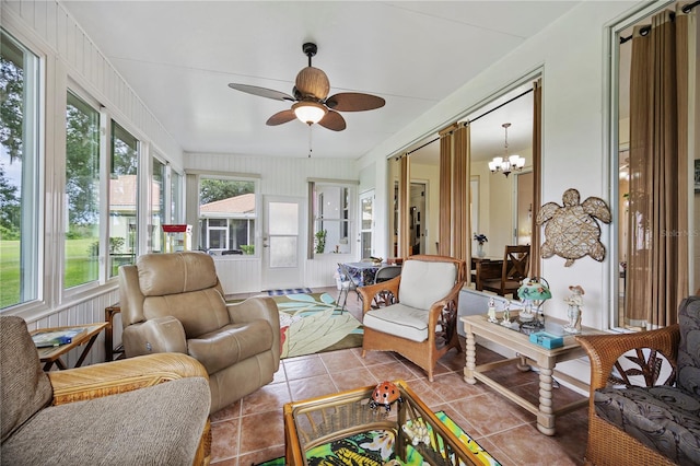 sunroom / solarium with ceiling fan with notable chandelier