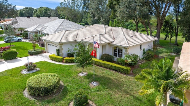 view of front facade with a garage and a front lawn