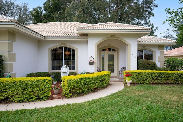 entrance to property featuring a lawn