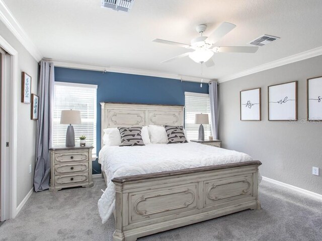 carpeted bedroom with multiple windows, crown molding, and ceiling fan