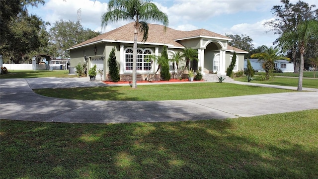 view of front facade featuring a garage and a front lawn