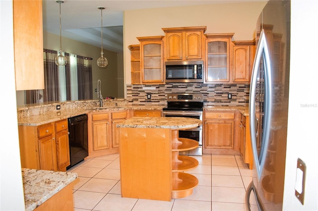 kitchen with a kitchen bar, appliances with stainless steel finishes, tasteful backsplash, sink, and a center island