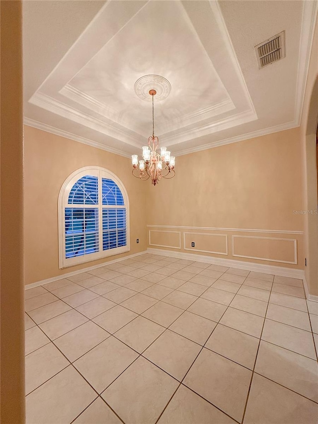 unfurnished dining area with a raised ceiling, light tile patterned floors, an inviting chandelier, and ornamental molding