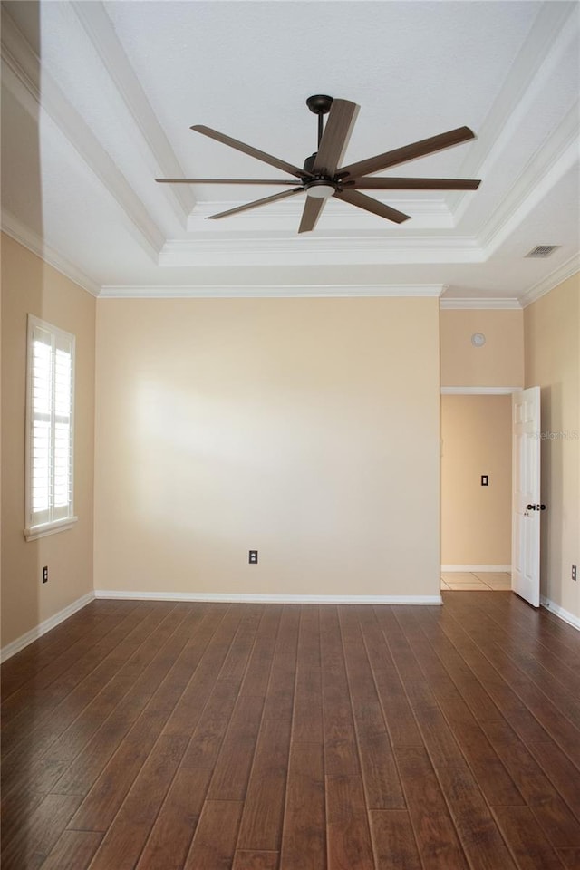 unfurnished room with dark hardwood / wood-style floors, a raised ceiling, ceiling fan, and crown molding