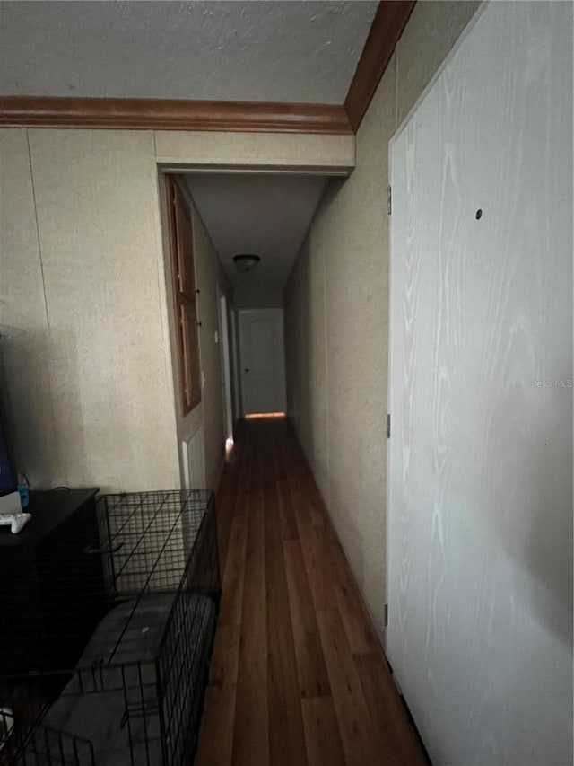 hallway featuring hardwood / wood-style floors and crown molding