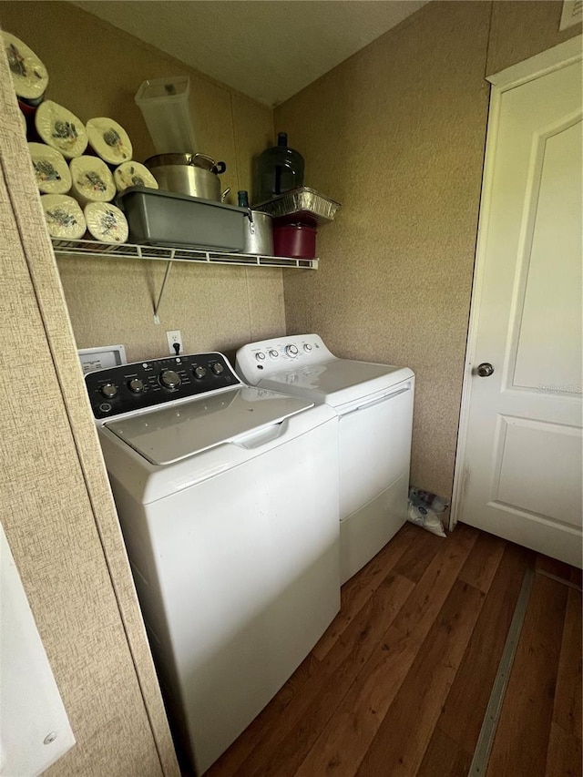 laundry room with washer and clothes dryer and dark hardwood / wood-style floors