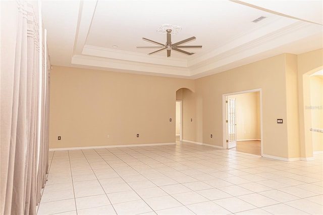 2638 E Knights Griffin Rd, Plant City, FL 33565 - unfurnished room featuring arched walkways, a raised ceiling, a ceiling fan, crown molding, and baseboards