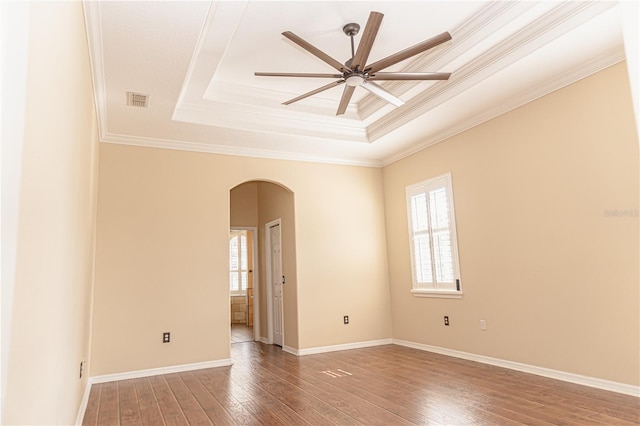2638 E Knights Griffin Rd, Plant City, FL 33565 - spare room with a raised ceiling, arched walkways, a ceiling fan, wood-type flooring, and ornamental molding