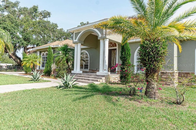 2638 E Knights Griffin Rd, Plant City, FL 33565 - mediterranean / spanish home featuring a front yard and stucco siding
