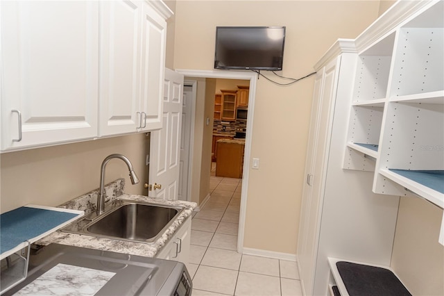2638 E Knights Griffin Rd, Plant City, FL 33565 - kitchen with light tile patterned floors, a sink, white cabinetry, decorative backsplash, and light countertops