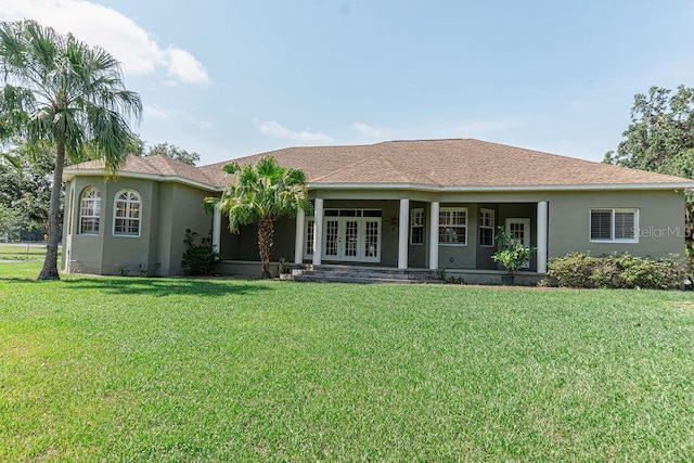 2638 E Knights Griffin Rd, Plant City, FL 33565 - back of house with french doors, stucco siding, and a yard