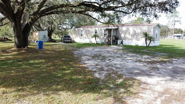 2638 E Knights Griffin Rd, Plant City, FL 33565 - view of front facade with entry steps and a front yard