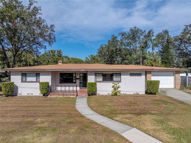 single story home with a garage, covered porch, and a front lawn