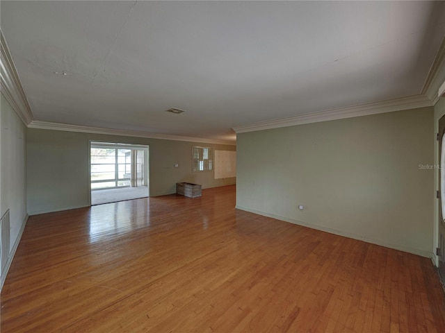 unfurnished room with light wood-type flooring and crown molding