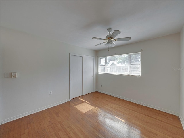 unfurnished bedroom featuring a closet, ceiling fan, and light hardwood / wood-style flooring