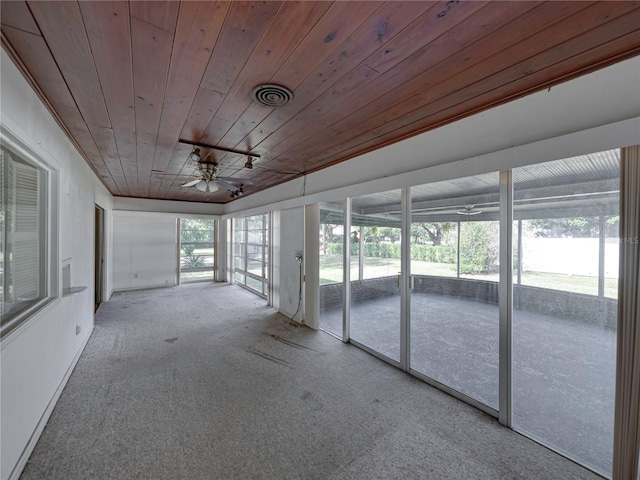 unfurnished sunroom featuring ceiling fan and wood ceiling